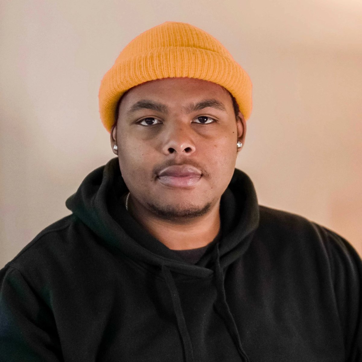 Isaiah G, wearing a yellow beanie and a black hoodie